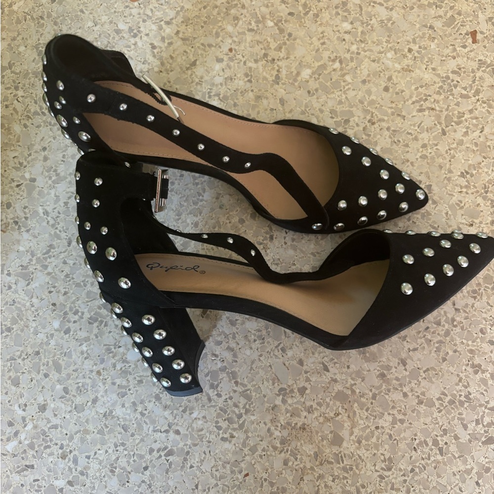 Studded black and silver closed toe heels.